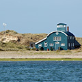 The iconic Blakeney lifeboat house from the water